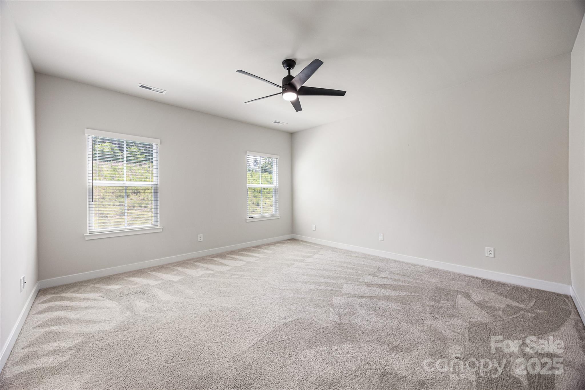2040 Dornoch Road Tega Cay, SC 29708 - Photo 16 of 30 an empty room with windows and fan