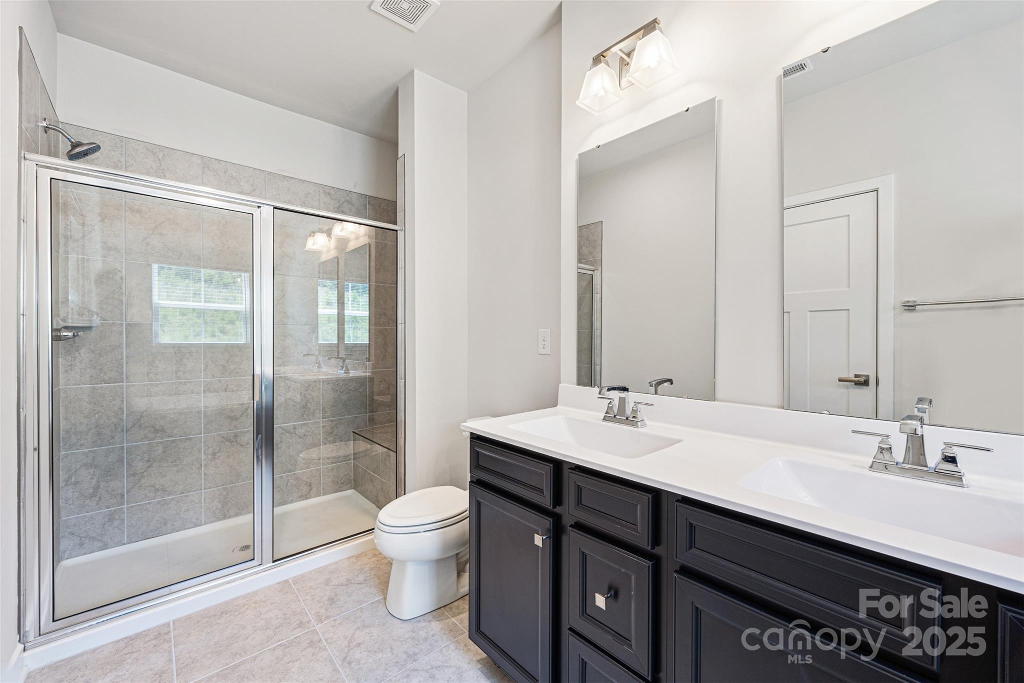 2040 Dornoch Road Tega Cay, SC 29708 - Photo 18 of 30 a bathroom with a sink double vanity and a shower