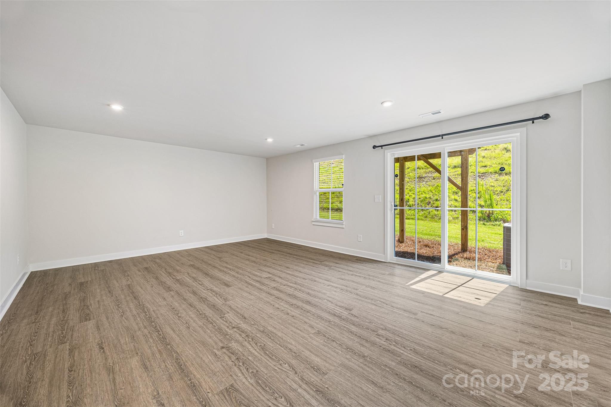 2040 Dornoch Road Tega Cay, SC 29708 - Photo 3 of 30 an empty room with wooden floor and windows