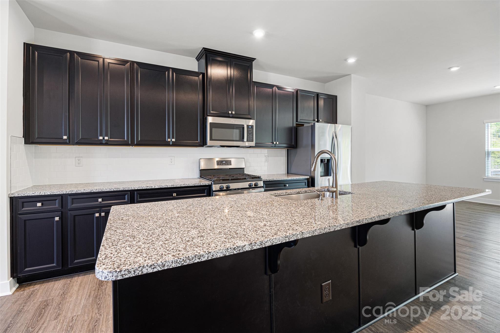 2040 Dornoch Road Tega Cay, SC 29708 - Photo 7 of 30 a kitchen with stainless steel appliances granite countertop a sink stove and refrigerator