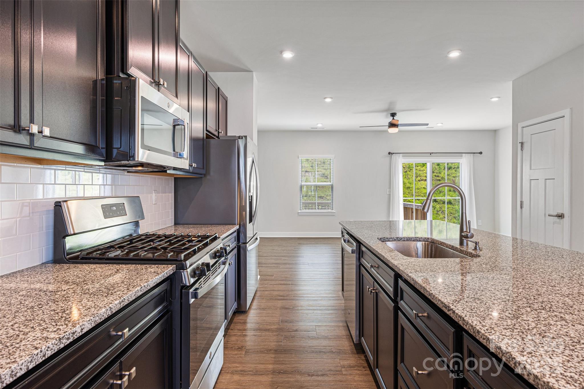 2040 Dornoch Road Tega Cay, SC 29708 - Photo 8 of 30 a kitchen with stainless steel appliances granite countertop a sink stove and cabinets