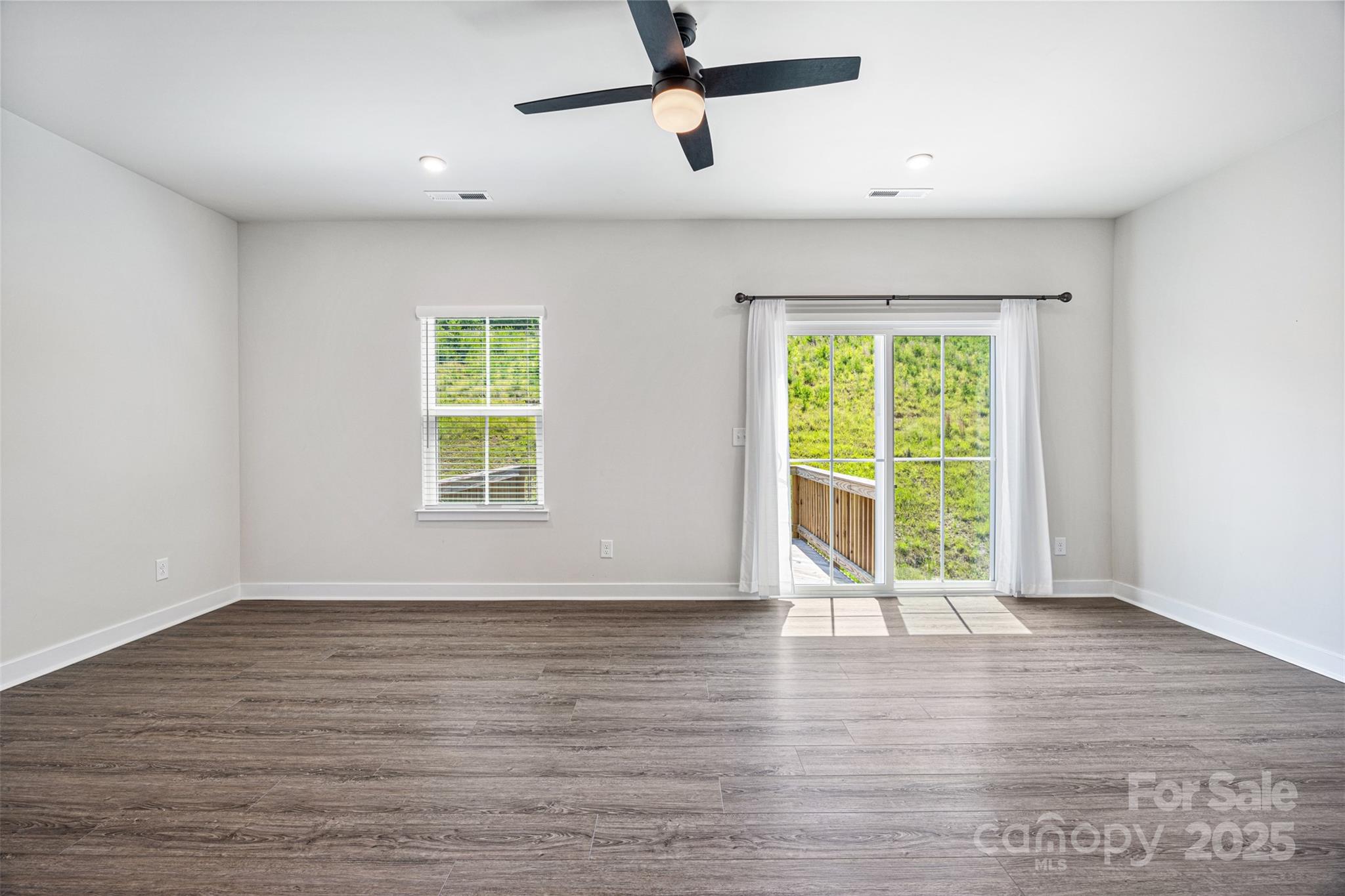 2040 Dornoch Road Tega Cay, SC 29708 - Photo 10 of 30 a view of an empty room with wooden floor and a window