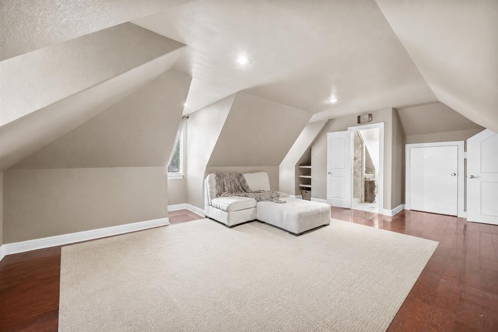 219 Mohundro Road Ferris, TX 75125 - Photo 34 of 40 a large white bed in a large room with wooden floor