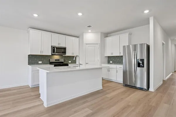 a kitchen with sink and stove