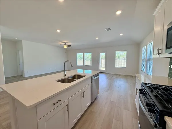 a kitchen with a sink a stove and refrigerator