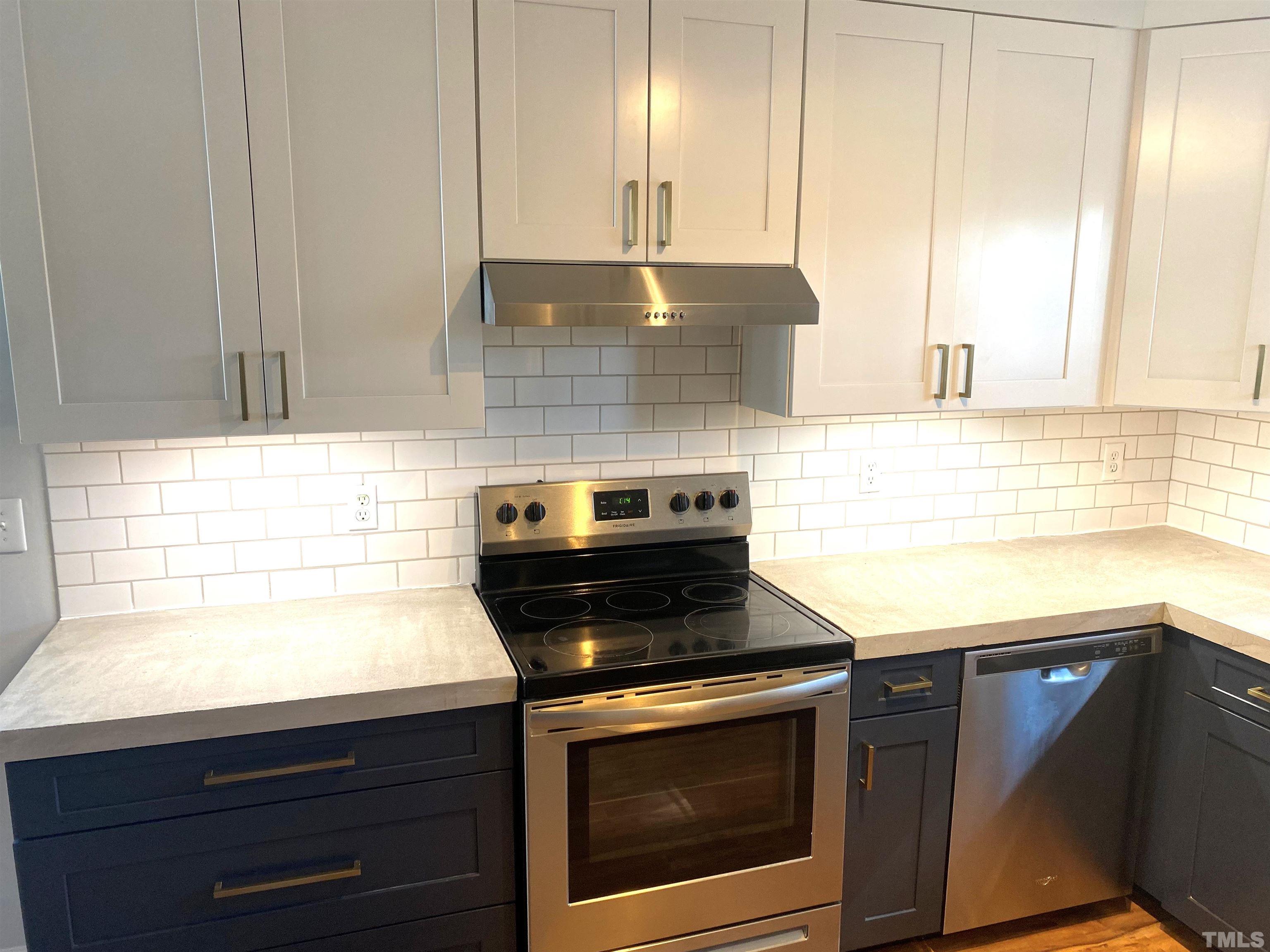 5104 Gable Ridge Drive Durham, NC 27713 - Photo 6 of 16 a kitchen with granite countertop a stove a sink and a microwave