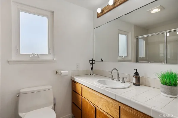 a white toilet sitting next to a bathroom sink