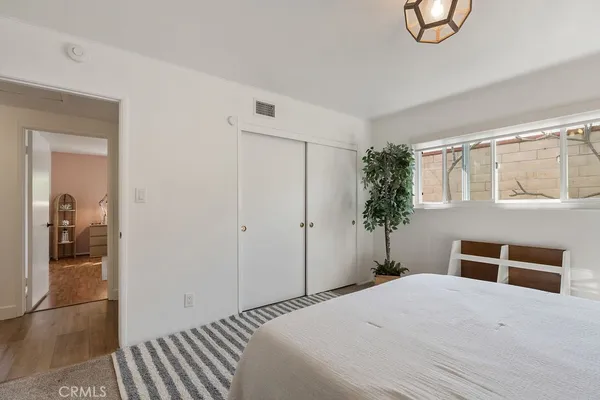 a bedroom with a bed and a large mirror