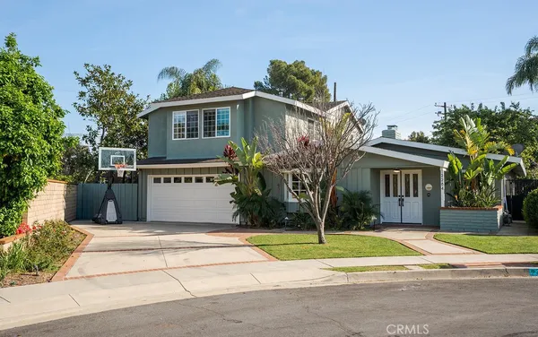 a house that has a tree in front of it