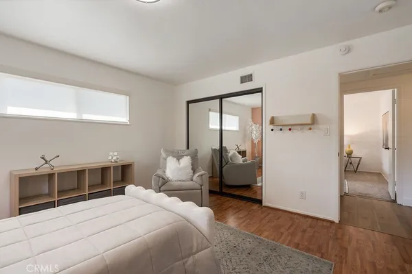 a bedroom with a bed and a potted plant