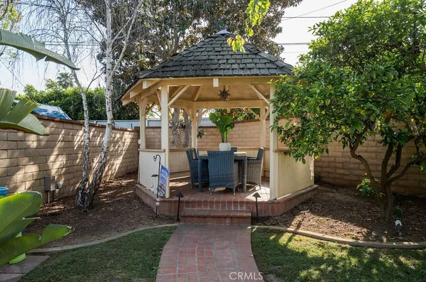 a view of a patio with couches chairs and a potted plant