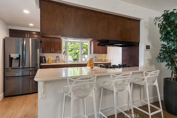 a kitchen with kitchen island a counter top space a sink and cabinets