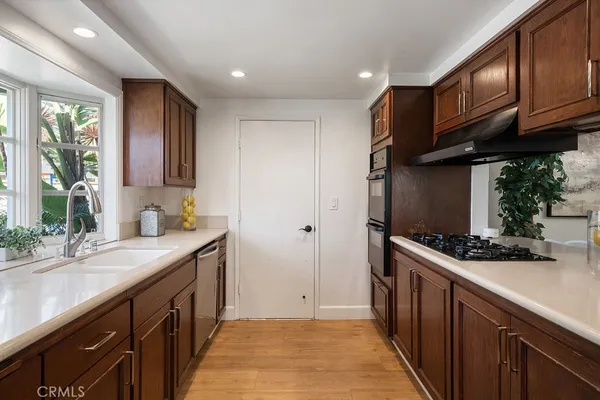 a kitchen with stainless steel appliances granite countertop a sink stove and cabinets