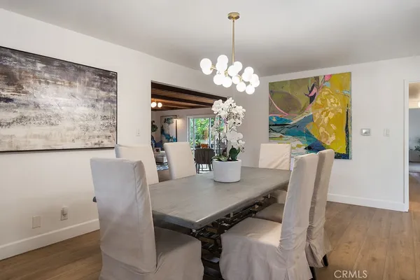 a view of a dining room with furniture wooden floor and a chandelier