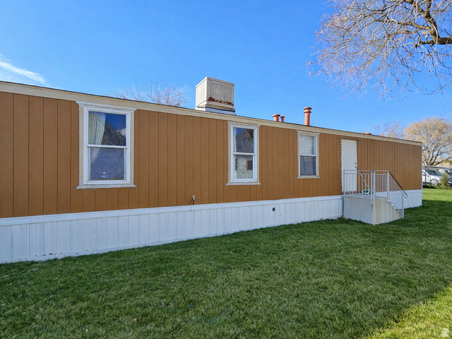 340 West 920 South, Unit 16 Provo, UT 84601 - Photo 3 of 15 View of property exterior featuring a lawn and a central air condition unit