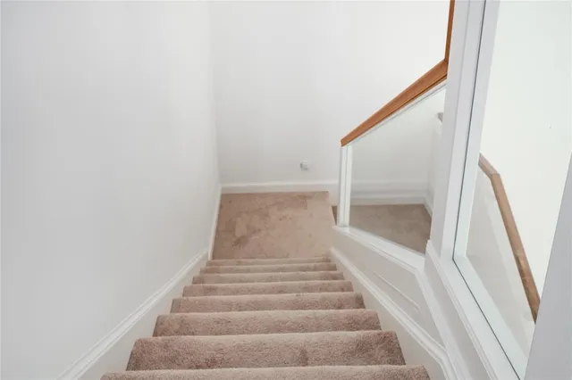 an empty room with a ceiling fan and a large window