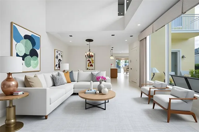 a living room with furniture a fireplace and a large window