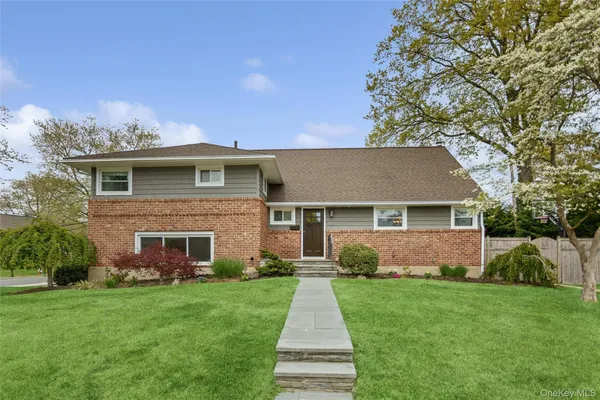 a front view of house with yard and green space