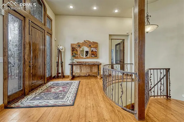 a view of a dining room with furniture a chandelier and wooden floor