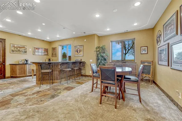 a spacious bathroom with a granite countertop sink a mirror and a shower