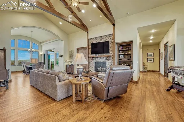 a living room with fireplace furniture and a flat screen tv