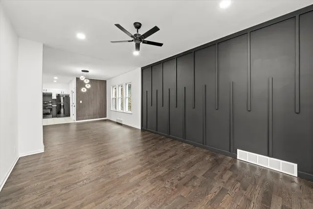 a view of a livingroom with a hardwood floor and staircase