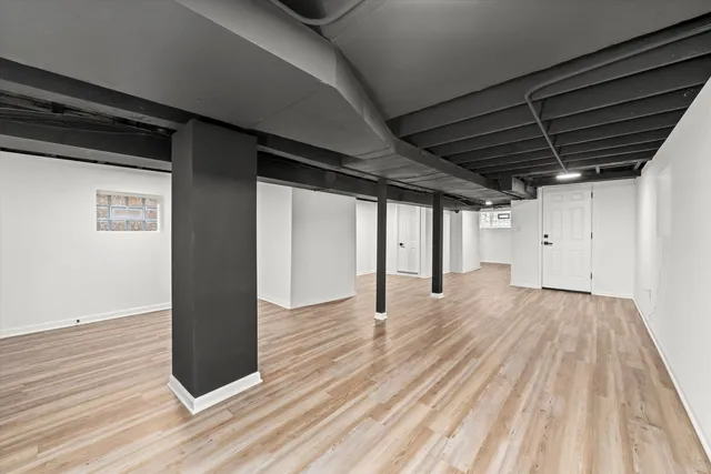 a view of hallway with wooden floor