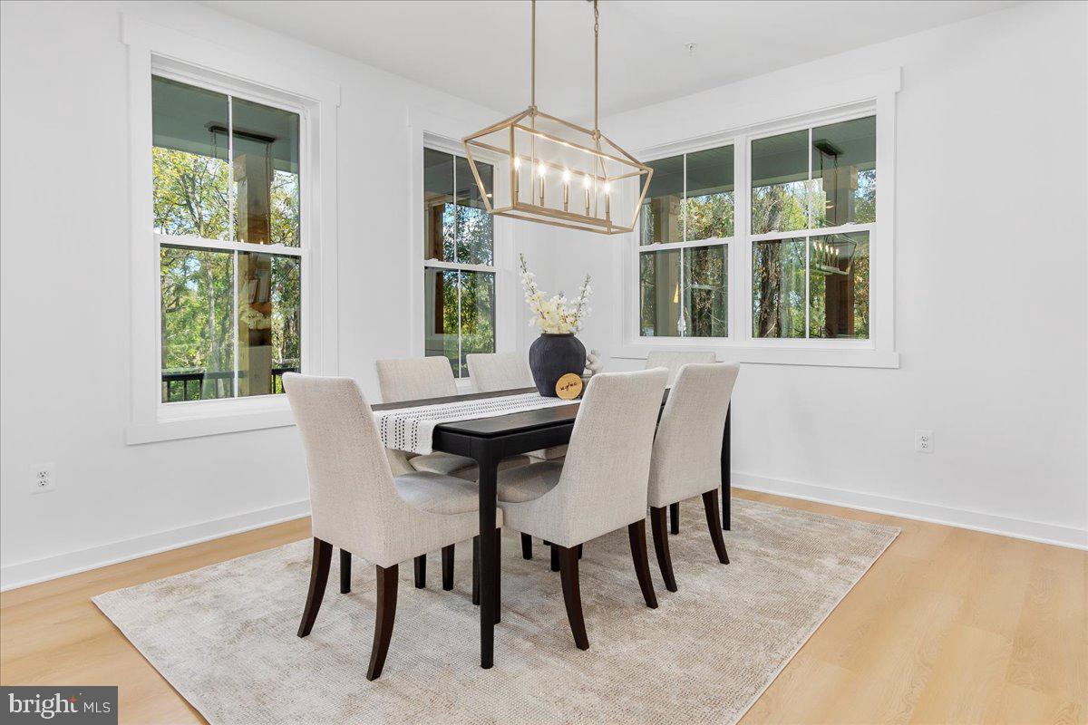 6508 Shady Side Road Shady Side, MD 20764 - Photo 11 of 35 a dining room with furniture a rug and a window