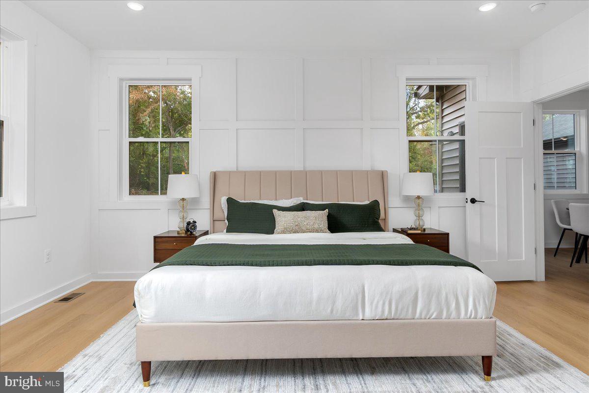 6508 Shady Side Road Shady Side, MD 20764 - Photo 15 of 35 a bedroom with a bed and wooden floor