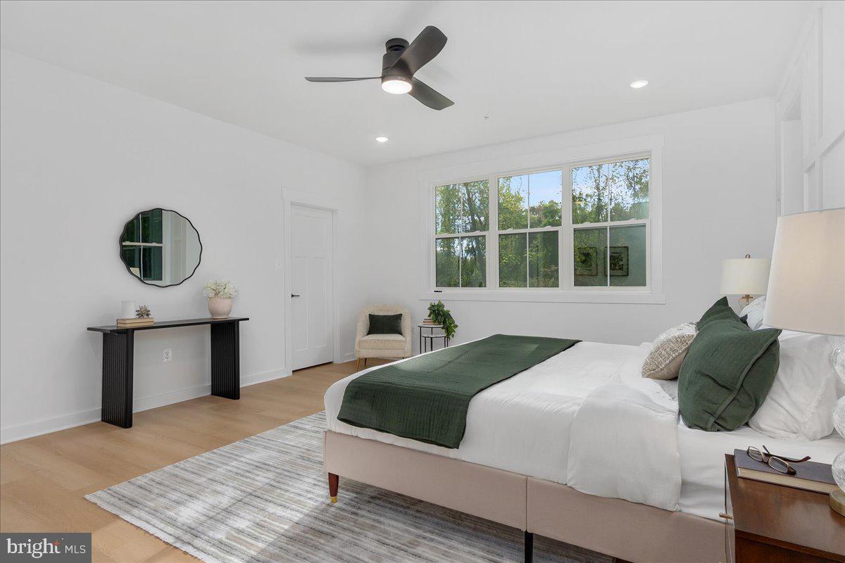 6508 Shady Side Road Shady Side, MD 20764 - Photo 16 of 35 a bedroom with a bed a mirror and window