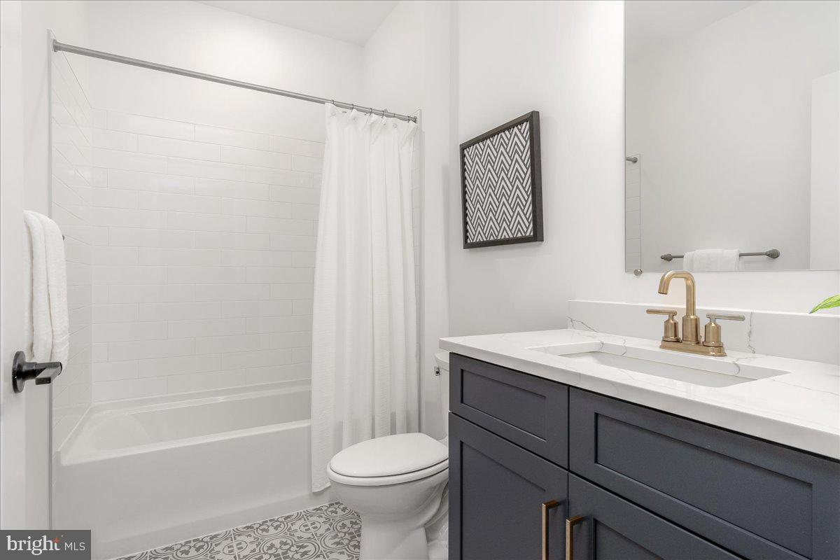 6508 Shady Side Road Shady Side, MD 20764 - Photo 21 of 35 a bathroom with a sink toilet and shower
