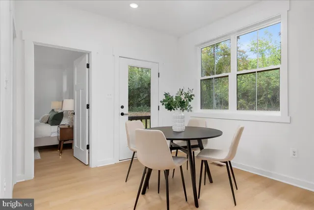 a dining room with furniture a rug and a window