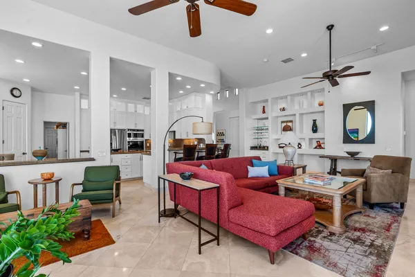 a kitchen with kitchen island granite countertop a sink and white cabinets
