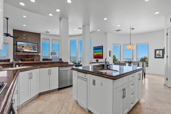 a kitchen with white cabinets and refrigerator