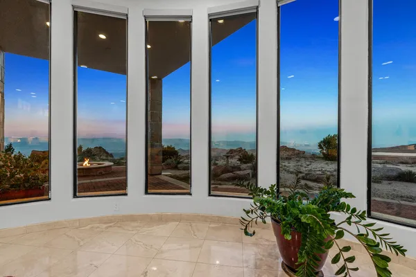 a spacious bedroom with a balcony a bed and a fireplace