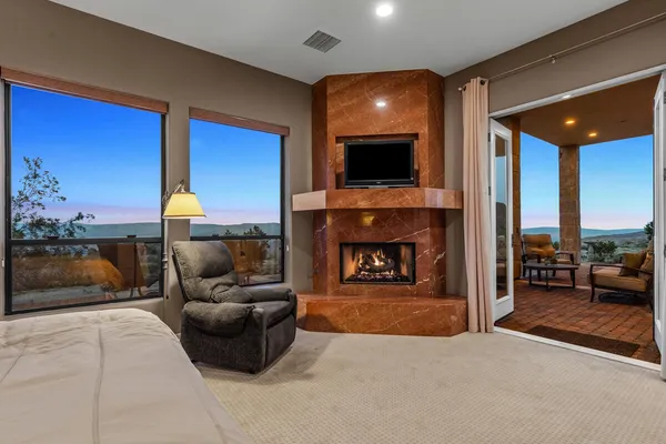 a bedroom with a bed and glass window