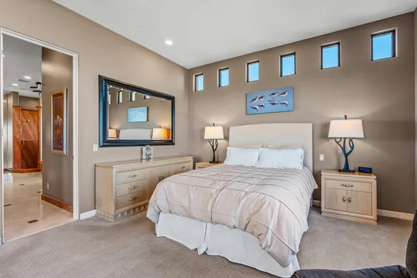 a bedroom with a bed and a chandelier