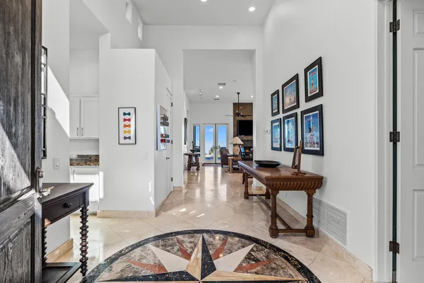 a living room with furniture kitchen view and a large window