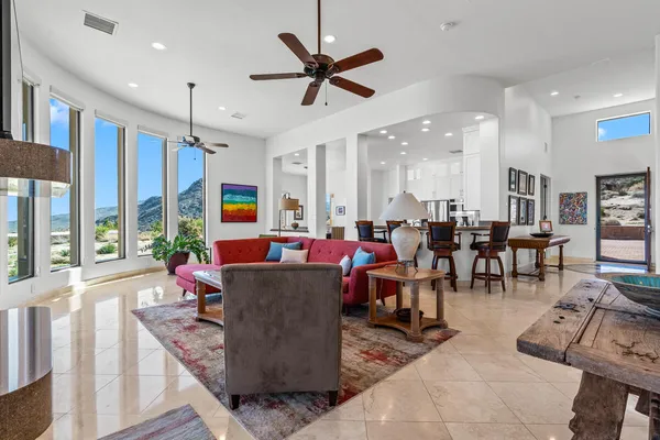 a living room with furniture and a chandelier