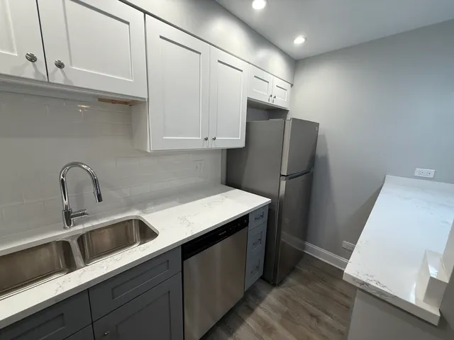 a kitchen with stainless steel appliances a refrigerator and a sink