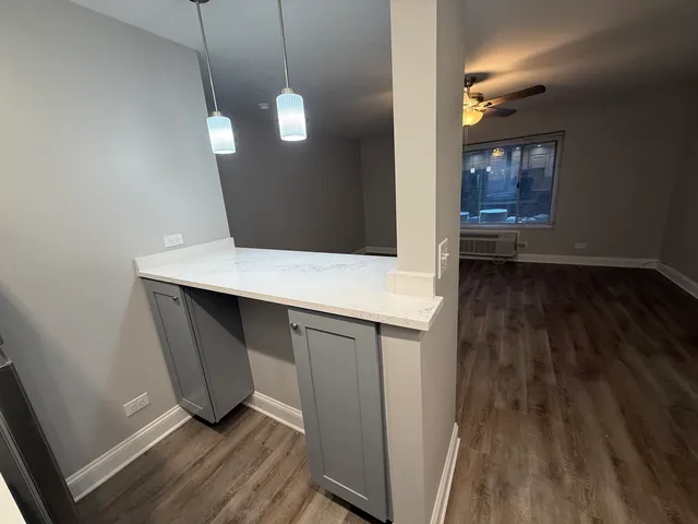 a room with wooden floor and white walls