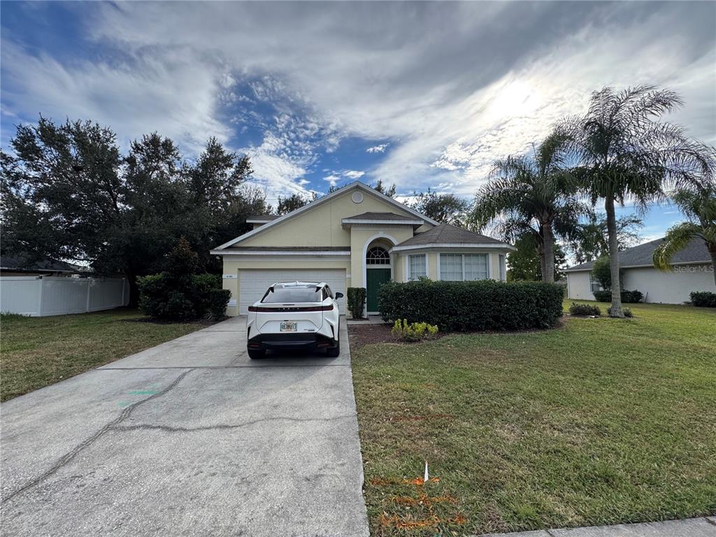 4190 Bear Gully Road Winter Park, FL 32792 - Photo 1 of 30 a front view of a house with a garden and trees