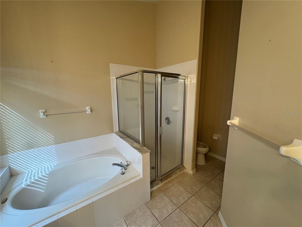 4190 Bear Gully Road Winter Park, FL 32792 - Photo 18 of 30 a bathroom with a bathtub and a shower