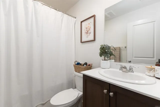 a bathroom with a sink a toilet and mirror