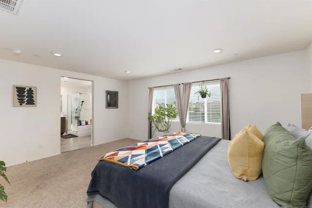 a bedroom with a large bed and a large window