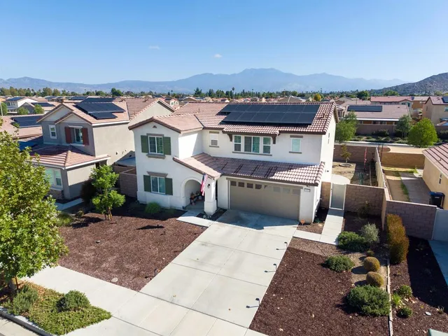an aerial view of a house with a yard