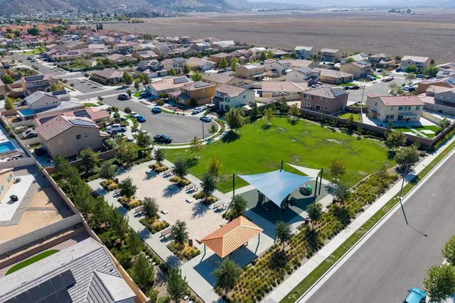 an aerial view of a residential houses with outdoor space