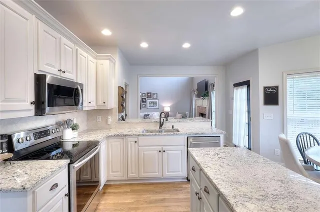 a kitchen with a sink stove top oven and refrigerator