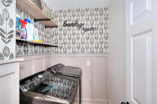 a living room with furniture a rug and a wall painting