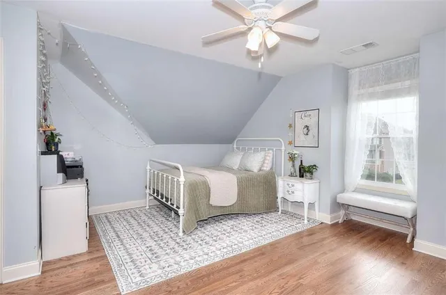 a bathroom with a shower curtain and a window
